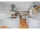 Kitchen showcasing an island cooktop, stainless steel appliances, and white countertops at 2865 S Cherry Way, Denver, CO 80222