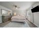 Neutral bedroom with dresser, ceiling fan, and plush bedding at 2865 S Cherry Way, Denver, CO 80222