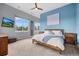 Spacious bedroom with a large bed, nightstands, ample natural light, and scenic views at 3063 E 148Th Pl, Thornton, CO 80602