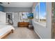 Bright bedroom featuring a large window, dresser, and wall-mounted television at 3063 E 148Th Pl, Thornton, CO 80602