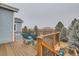 Outdoor deck area with natural wood stairs and railings offering scenic views of the trees and landscape at 3063 E 148Th Pl, Thornton, CO 80602
