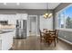 Cozy dining area with wood floors, a chandelier, and a view to the backyard at 3063 E 148Th Pl, Thornton, CO 80602