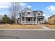 Charming two-story home with a welcoming front porch and well-maintained lawn at 3063 E 148Th Pl, Thornton, CO 80602