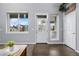 Bright foyer featuring hardwood floors, decorative front door, and ample natural light at 3063 E 148Th Pl, Thornton, CO 80602
