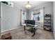 Bright home office with large windows, a modern desk, and comfortable seating at 3063 E 148Th Pl, Thornton, CO 80602