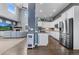 Modern kitchen with stainless steel appliances, white cabinetry, and hardwood floors at 3063 E 148Th Pl, Thornton, CO 80602