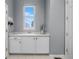 Bright laundry room featuring white cabinetry, a sink, and a window for natural light at 3063 E 148Th Pl, Thornton, CO 80602