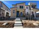 Modern two-story home with a stone facade and a welcoming front porch at 6591 N Netherland St, Aurora, CO 80019