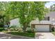 White house with a large tree and driveway at 4530 S Verbena St # 332, Denver, CO 80237