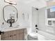 Modern bathroom with sleek vanity, oval mirror, and bathtub/shower combination at 5128 W 26Th Ave # 208, Denver, CO 80212