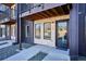 Close-up of a stylish apartment entrance with stone accents, a dark door, and modern design at 5128 W 26Th Ave # 208, Denver, CO 80212