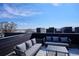 Serene rooftop deck with plush seating and stunning cityscape views, creating a perfect outdoor oasis at 5128 W 26Th Ave # 208, Denver, CO 80212