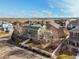 Aerial view showcasing the home's backyard with mature trees, surrounded by a white fence at 8775 Wild Horse Way, Frederick, CO 80504