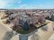 View of the gray home showing the neighborhood, surrounding streets, and the landscaped front yard at 8775 Wild Horse Way, Frederick, CO 80504