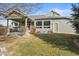 View of a house's backyard with a covered patio, green lawn, and well-maintained landscaping at 8775 Wild Horse Way, Frederick, CO 80504