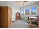 Inviting bedroom with ample natural light, wooden furnishings, and neutral carpet at 8775 Wild Horse Way, Frederick, CO 80504