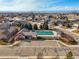 Aerial view of the community pool and clubhouse surrounded by homes in the neighborhood at 8775 Wild Horse Way, Frederick, CO 80504