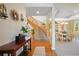 Inviting foyer with a curved staircase, hardwood floors, and views of the dining room at 8775 Wild Horse Way, Frederick, CO 80504