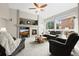 Spacious living room featuring a stone fireplace, large windows, and comfortable seating at 8775 Wild Horse Way, Frederick, CO 80504