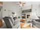 Bright living room showcasing a fireplace, mantel decor, and ample seating at 8775 Wild Horse Way, Frederick, CO 80504