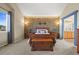 Spacious main bedroom featuring a stone accent wall and ensuite bathroom access at 8775 Wild Horse Way, Frederick, CO 80504