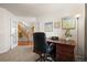 Inviting home office with dark wood desk and views of the entry and staircase at 8775 Wild Horse Way, Frederick, CO 80504