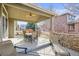 Covered patio with seating area and ceiling fan for outdoor dining and relaxation at 8775 Wild Horse Way, Frederick, CO 80504