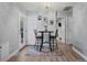 Dining area with a modern rug features a breakfast nook with access to the backyard and an open floorplan at 16120 E Radcliff Pl, Aurora, CO 80015
