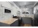 Gray cabinets and countertops highlight this home kitchen with tile backsplash, a microwave, and stainless steel appliances at 16120 E Radcliff Pl, Aurora, CO 80015