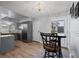 Stylish kitchen with bar seating, stainless steel appliances, and wood-look floors at 16120 E Radcliff Pl, Aurora, CO 80015