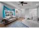 Cozy living room with comfortable seating, a large window, and bright lighting at 16120 E Radcliff Pl, Aurora, CO 80015