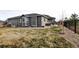 Spacious backyard with a covered patio, privacy fence, and well-maintained lawn with mature landscaping at 26554 E Indore Ave, Aurora, CO 80016