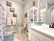 Bathroom featuring beach themed decor, white vanity, and tile flooring at 26554 E Indore Ave, Aurora, CO 80016
