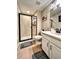 Clean, earth-toned bathroom featuring a glass shower, vanity, and toilet at 26554 E Indore Ave, Aurora, CO 80016