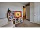 Cozy room featuring carpeted floors, a soft chair, and a decorative bookshelf at 26554 E Indore Ave, Aurora, CO 80016