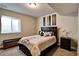 Bedroom featuring carpeted floor, queen bed, and a nightstand with lamp at 26554 E Indore Ave, Aurora, CO 80016