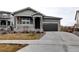 Charming single-Gathering home with a gray exterior, covered porch, and attached two-car garage at 26554 E Indore Ave, Aurora, CO 80016