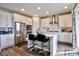 Modern kitchen with white cabinets, stainless steel appliances, a kitchen island, and hardwood flooring at 26554 E Indore Ave, Aurora, CO 80016