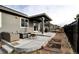 A covered patio with an outdoor seating area, fire pit, and garden boxes, perfect for entertaining and relaxing at 26554 E Indore Ave, Aurora, CO 80016