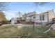 Large grassy backyard with a deck and playset at 12293 W Saratoga Ave, Morrison, CO 80465