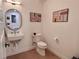 Modern bathroom with a floating vanity, toilet and wood-look flooring at 5128 W 26Th Ave # 208, Denver, CO 80212