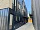 Rear view of townhomes, showing modern architecture and private alley access at 5128 W 26Th Ave # 208, Denver, CO 80212