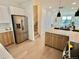 Open concept kitchen with stainless steel appliances and island at 5128 W 26Th Ave # 208, Denver, CO 80212