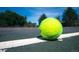 Tennis ball on a green tennis court at 5128 W 26Th Ave # 208, Denver, CO 80212