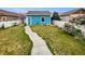 Charming backyard featuring green grass, a walkway, and a blue storage shed at 4548 Quandary Peak St, Brighton, CO 80601