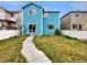Private backyard with lush lawn, concrete path, and white fencing at 4548 Quandary Peak St, Brighton, CO 80601