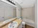 Clean bathroom features a shower-tub combo, a white sink, and wood-style flooring at 4548 Quandary Peak St, Brighton, CO 80601