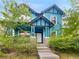 Charming two-story home featuring a vibrant blue exterior and well-manicured landscaping at 4548 Quandary Peak St, Brighton, CO 80601