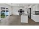 Modern kitchen with stainless appliances, island, hardwood floors, and sliding doors to the backyard at 4548 Quandary Peak St, Brighton, CO 80601