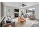 Cozy living room featuring a stone fireplace, plush seating, and ample natural light at 4548 Quandary Peak St, Brighton, CO 80601